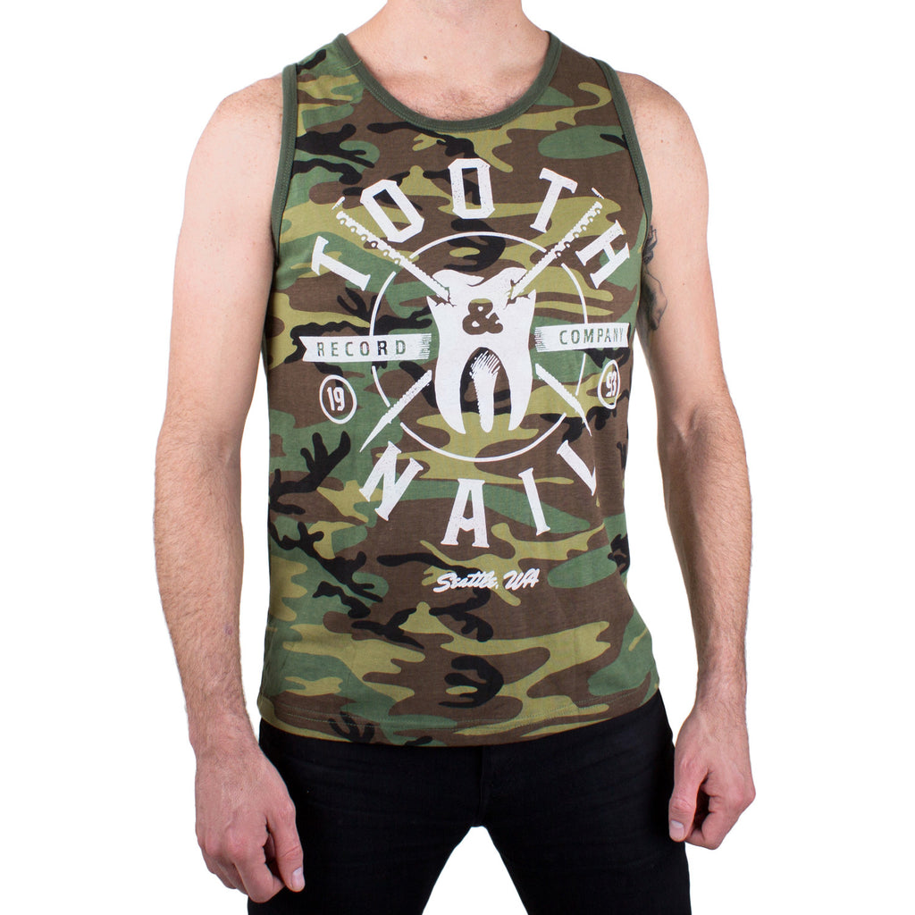 image of a man from the neck down wearing a camo tank top on a white background. tank has full front chest print in white that says tooth & Nail records company with a tooth with nails in the center of the tank