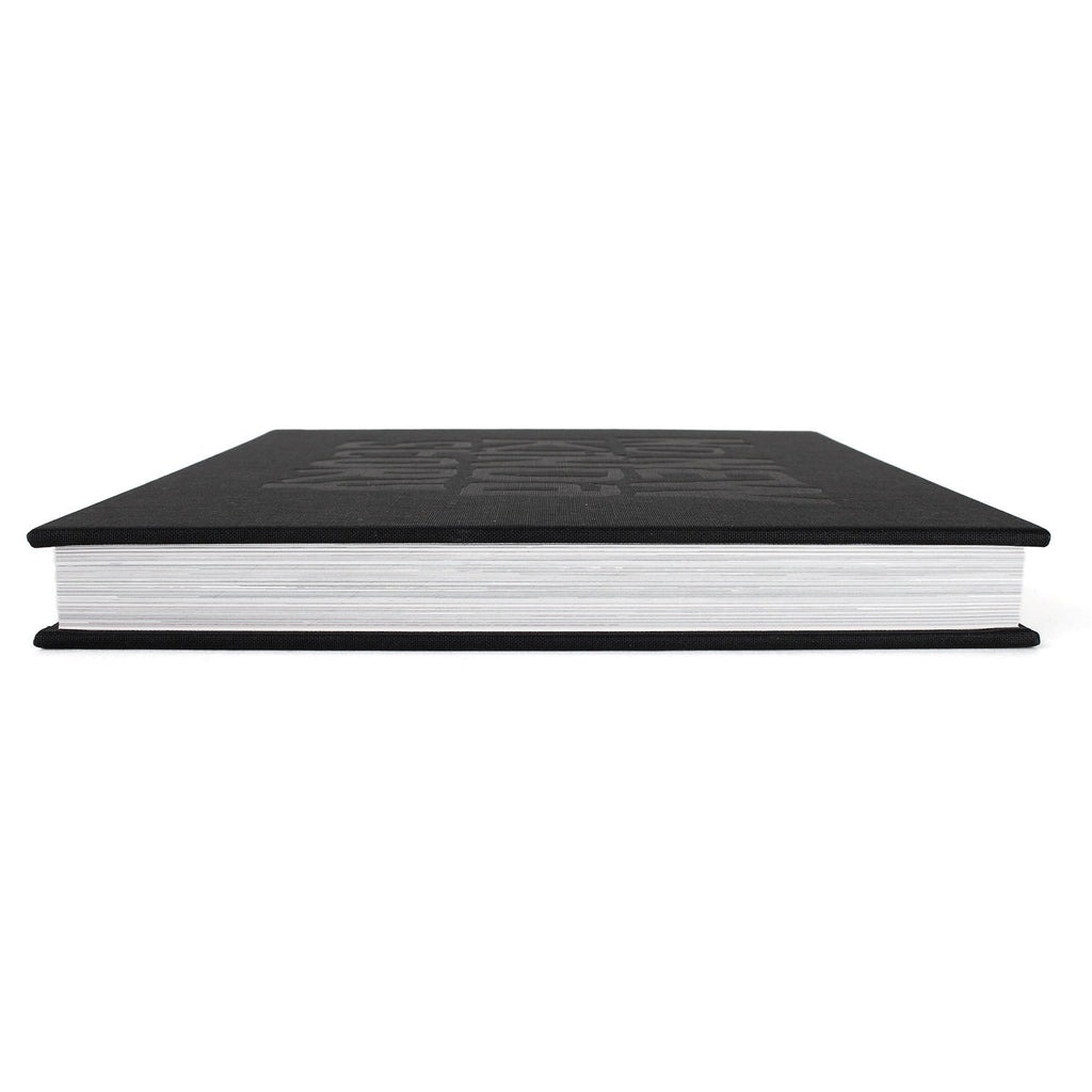 image of a black book on a white background. book is laid flat showing the thickness, which would estimate almost two inches thick, with a lot of pages