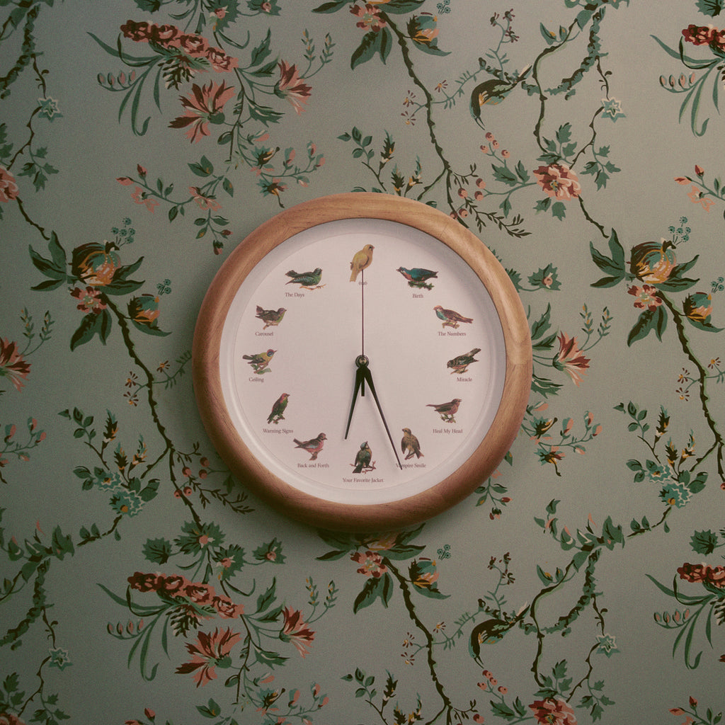 Image of Valleyheart Heal My Head Album Cover. Cover is floral wallpaper like background with a clock that has various birds instead of numbers. 