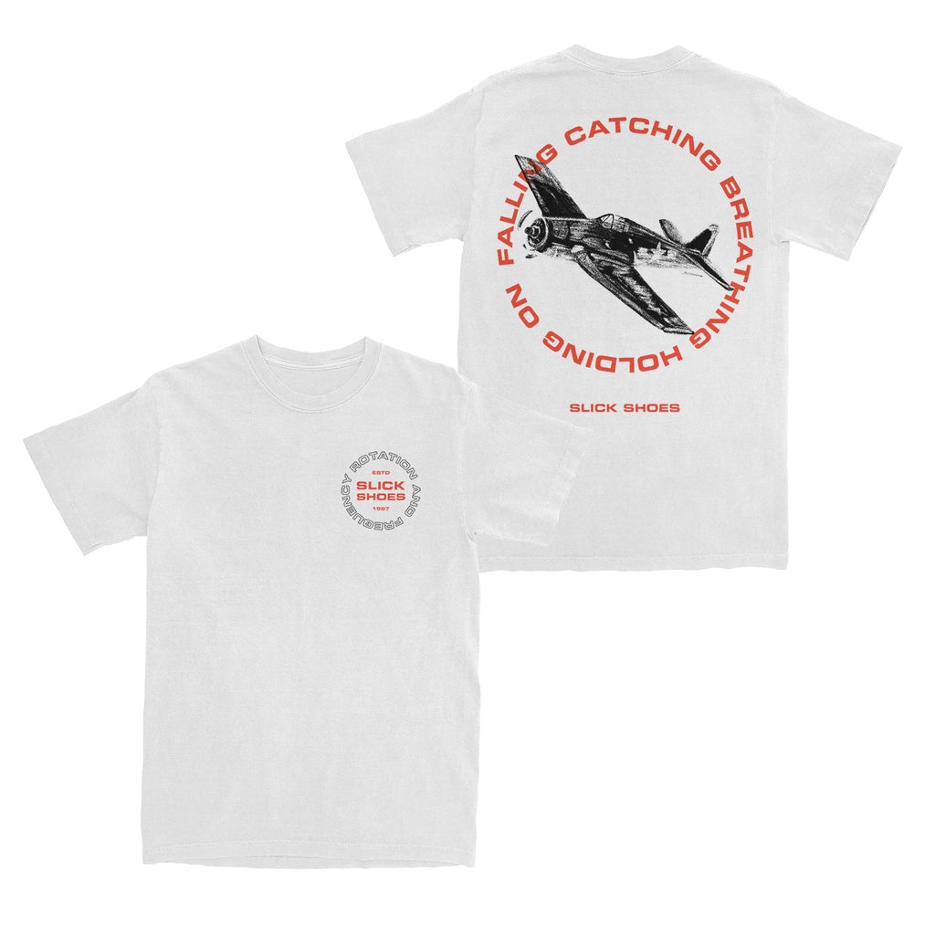 image of the front and back of a white tee shirt on a white background. the front of the tee is on the right and has a small chest print on the right that says in red slick shoes with a circle of black outline text around it that says rotation and frequency. the back of te tee is on the right and has a full back print. in the center in black is an airplane with red text around it that says falling catching breathing holding on and then slick shoes at the bottom