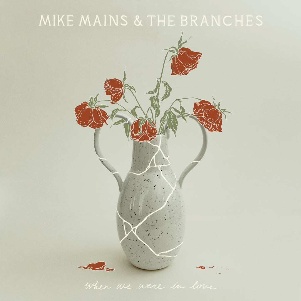 image of an album cover. at the top says mike mains & the branches. there is a cracked vace in the center, with illustrated red roses. at the bottom says when we were in love