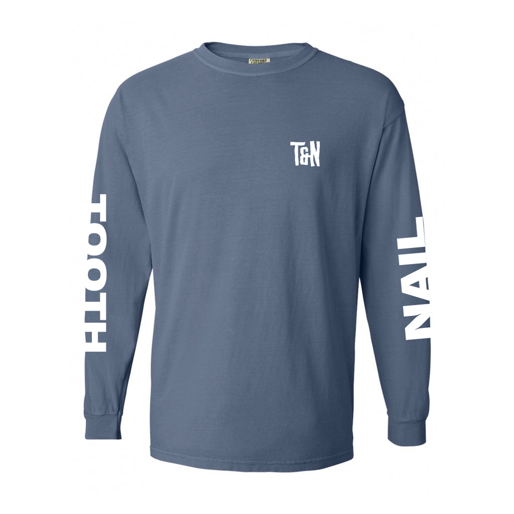 image of an ice blue long sleeve tee shirt on a white background. tee has a small chest print on the right in white that says T & N. White prints on both sleeves. The right says tooth and the left says nail